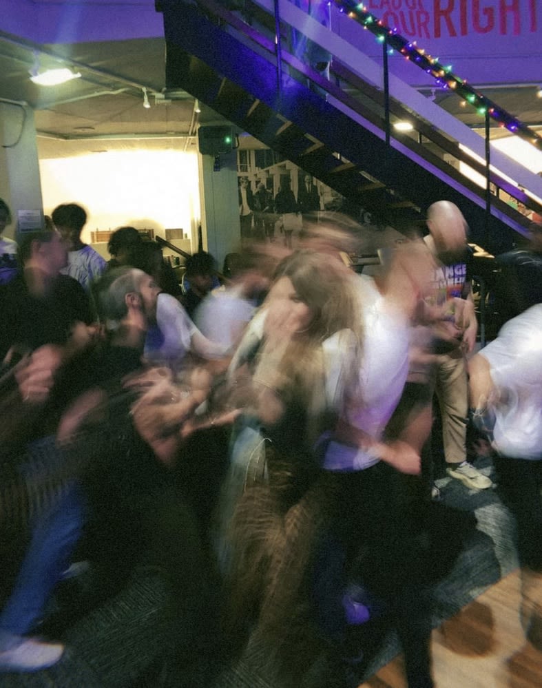 Blurry image of a group of people dancing